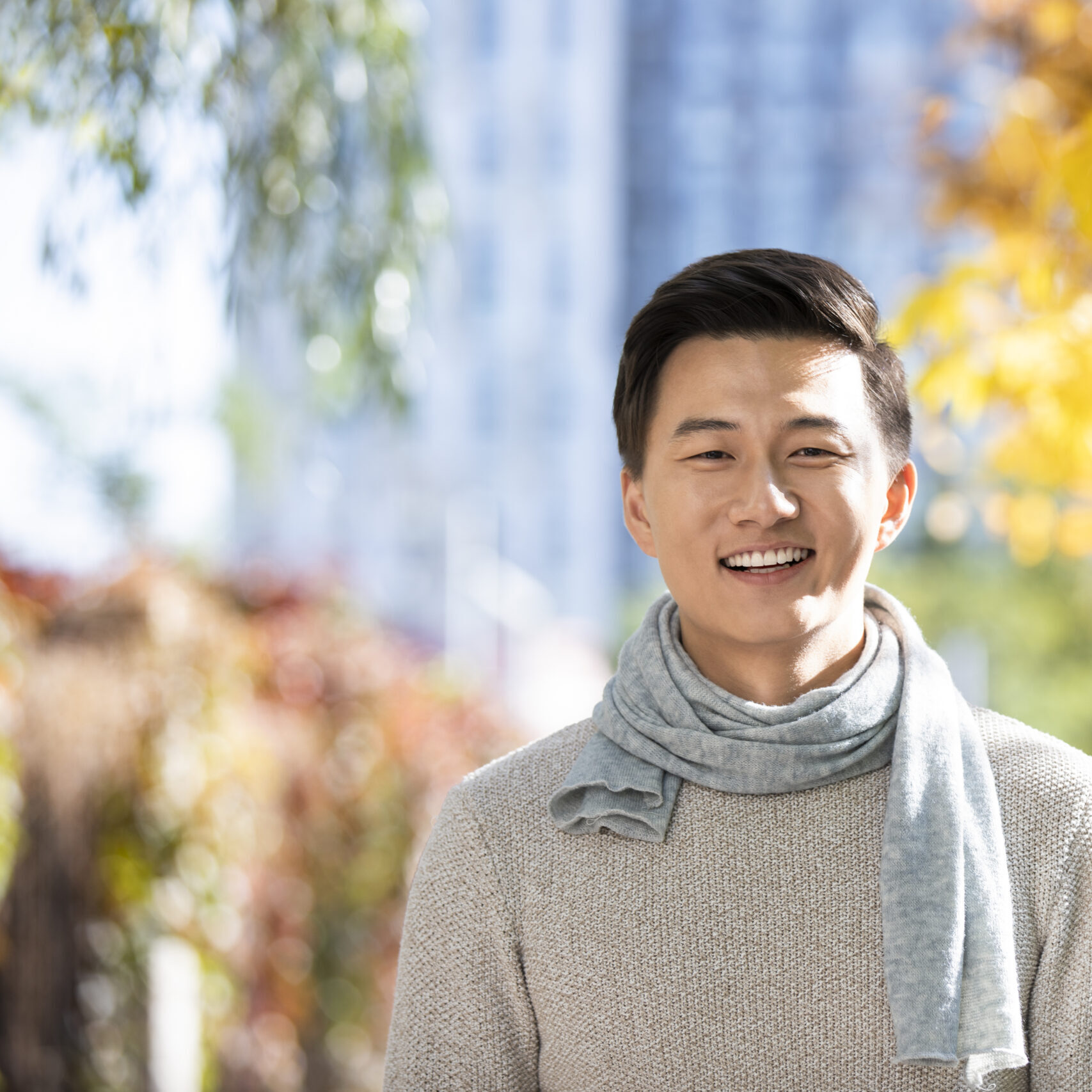 Portrait of smiling young Chinese man in autumn