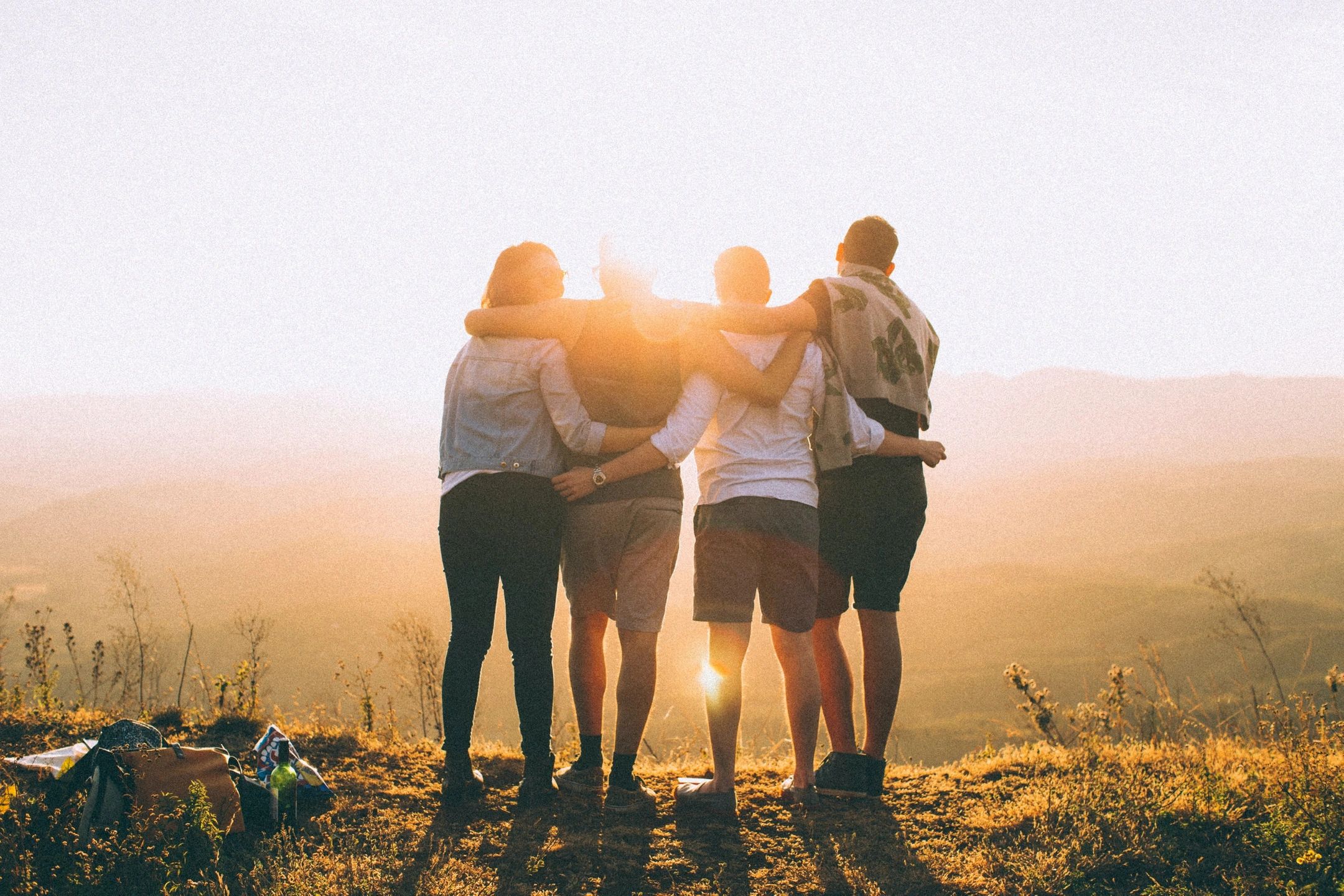 Friends with arms around each other's backs